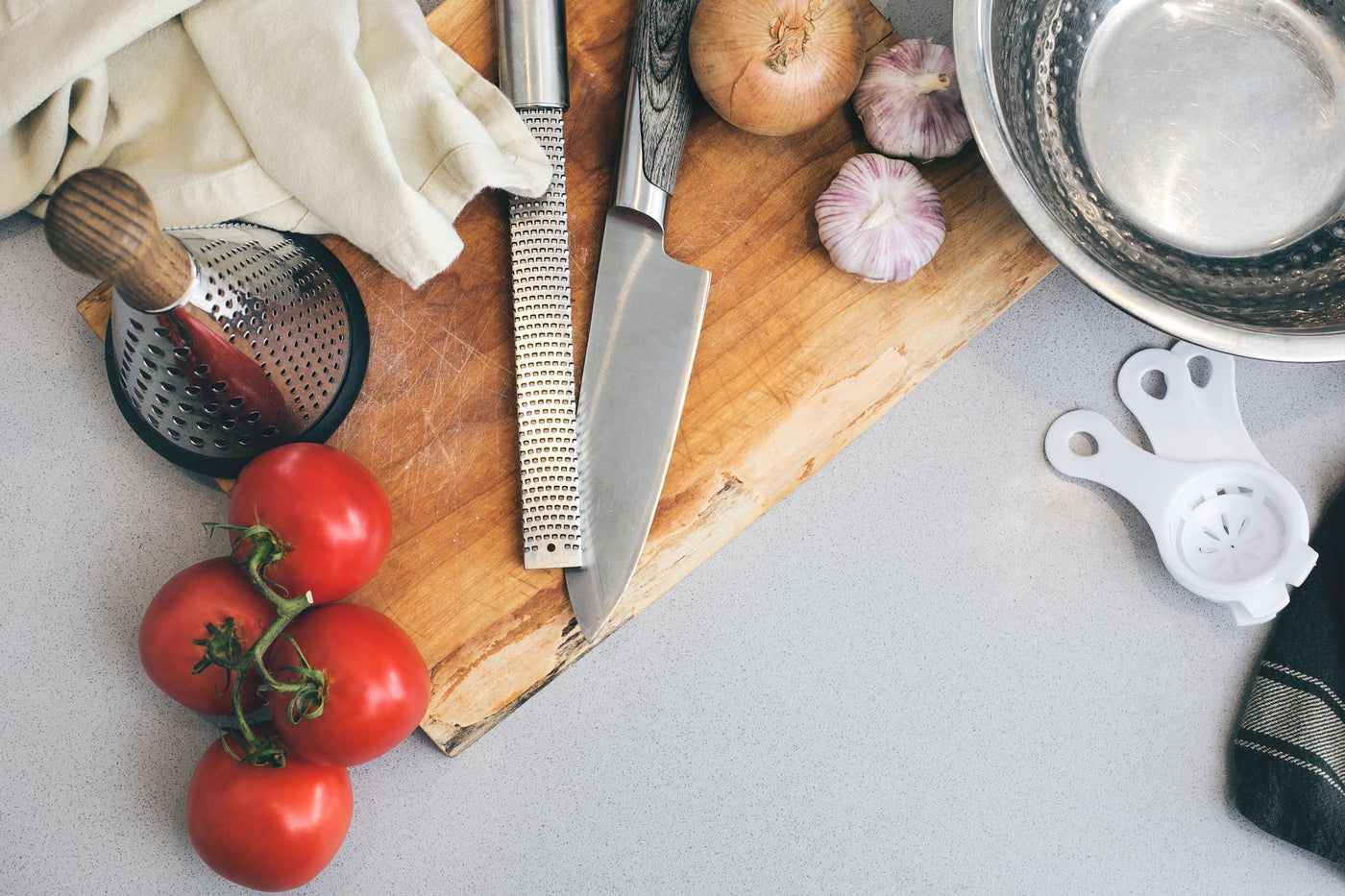 chopping board on a table with veggies and utensils